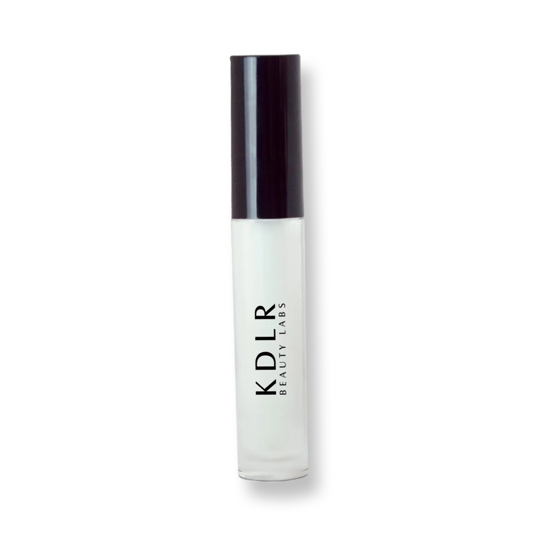 KDLR Beauty Labs' Power Drip Lip Gloss, showcasing radiant shine, full lips in shimmer and natural finishes, perfect for versatile, luxurious day-to-night lip makeup. Variant: Clear