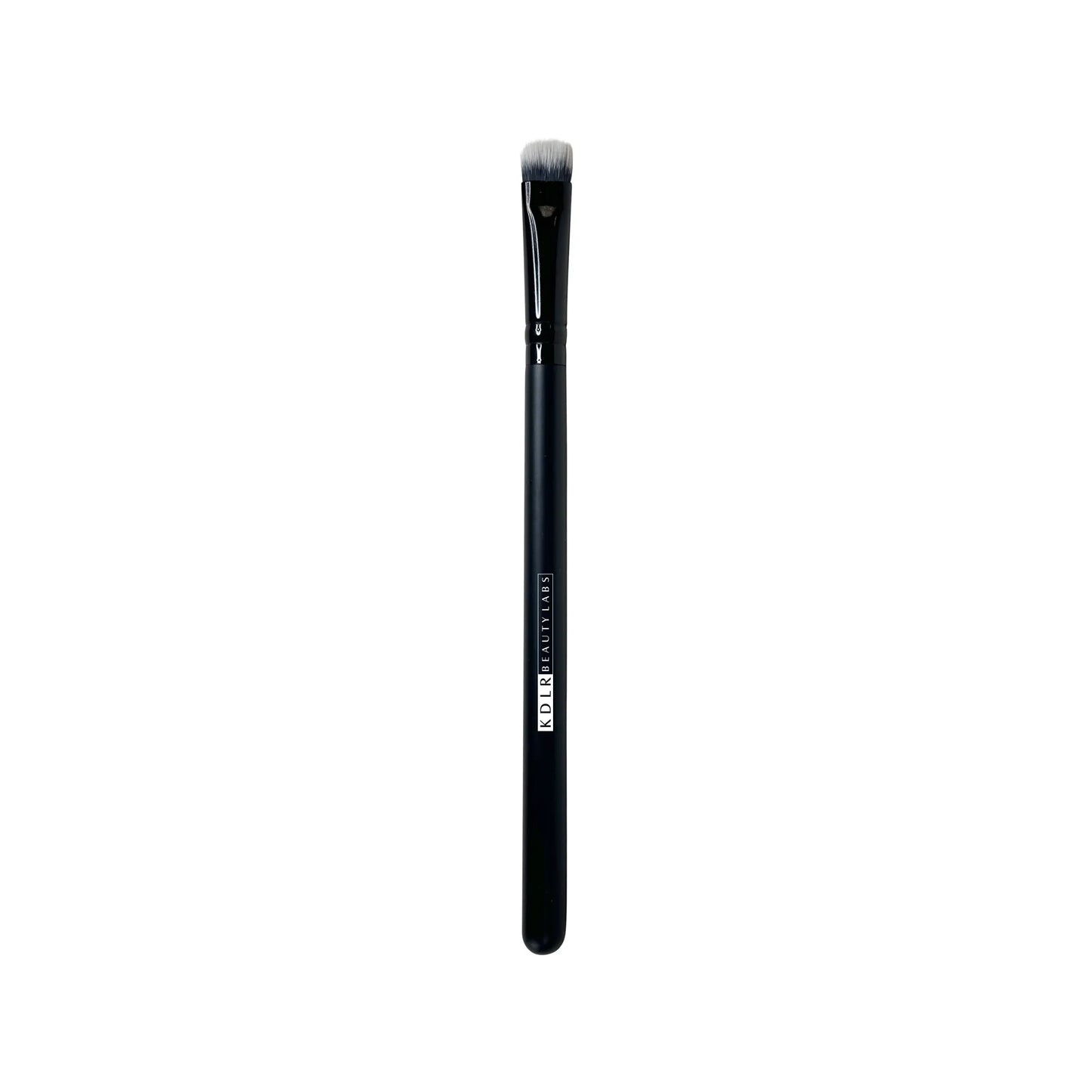 KDLR Beauty Labs Flat Pack and Layer brush, a flat, firm synthetic eyeshadow packing and lid shading brush with black and white bristles and a glossy black handle on a white background.