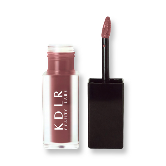 KDLR Beauty Labs' SatinMatte Lip Stain, featuring enduring color with a velvety matte finish for all-day wear, buildable shades, unique doe-shaped applicator, vitamin E enriched, and an eco-friendly, vegan formula. Variant: Blackberry Wine