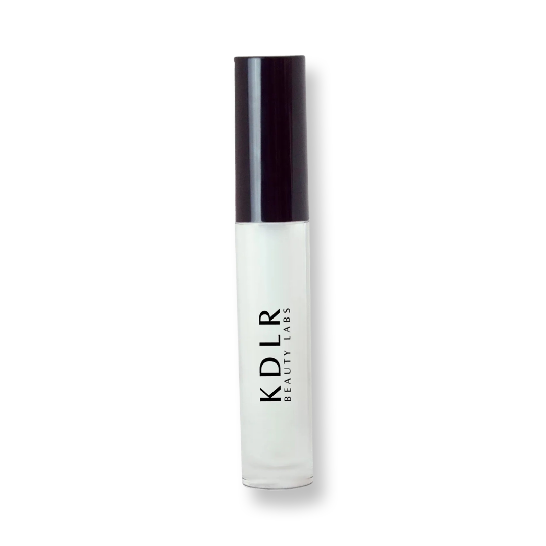 KDLR Beauty Labs' Power Drip Lip Gloss, showcasing radiant shine, full lips in shimmer and natural finishes, perfect for versatile, luxurious day-to-night lip makeup.  Variant: Clear