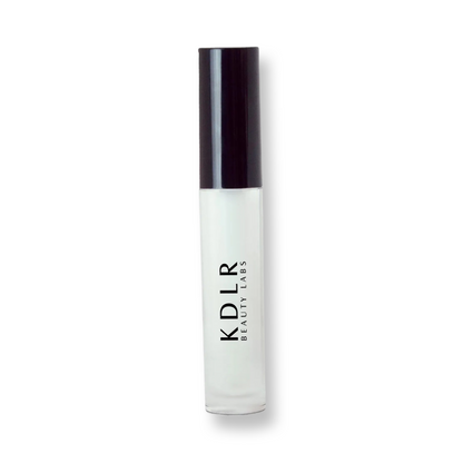 KDLR Beauty Labs' Power Drip Lip Gloss, showcasing radiant shine, full lips in shimmer and natural finishes, perfect for versatile, luxurious day-to-night lip makeup.  Variant: Clear