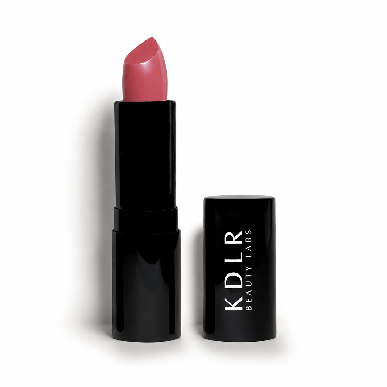 KDLR Beauty Labs Noir Patent Cream Lipstick in Darling Dahlia, a creamy rosy pink lipstick with a satin finish in glossy black packaging on a white studio background.