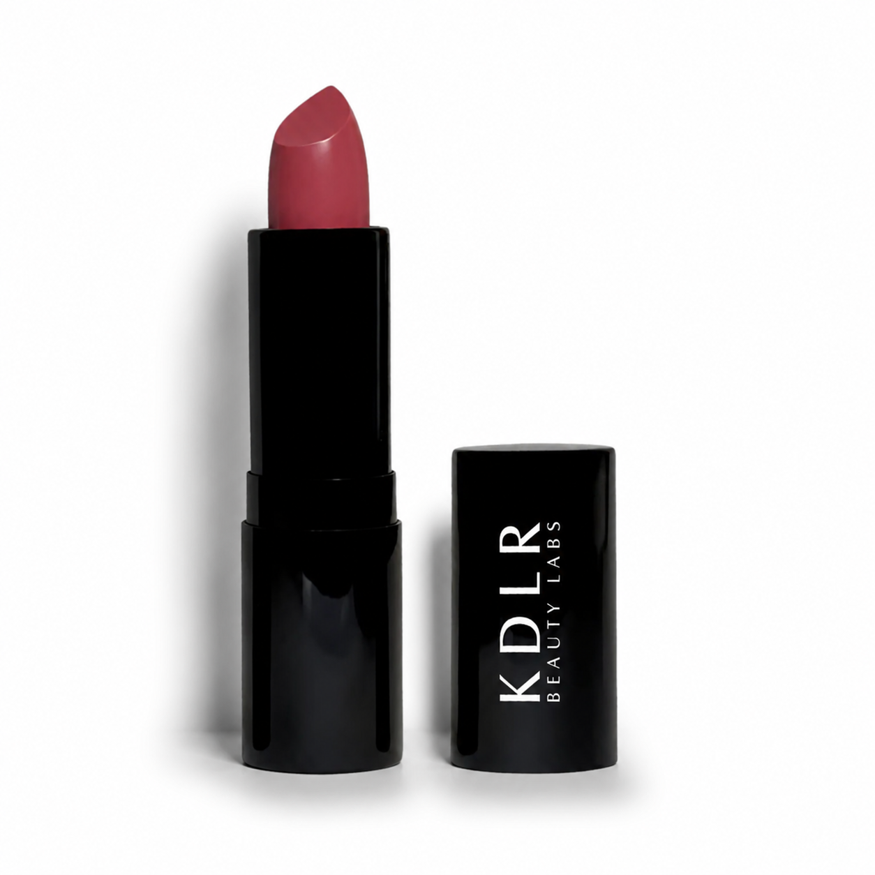 KDLR Beauty Labs Noir Patent Cream Lipstick in Rambling Rose, a creamy rosy mauve satin lipstick in glossy black packaging on a white studio background.