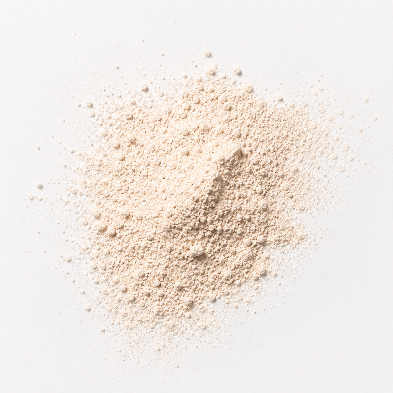 Loose soft-focus finishing powder texture in a light neutral tone with an ultra-fine matte finish on a clean white background