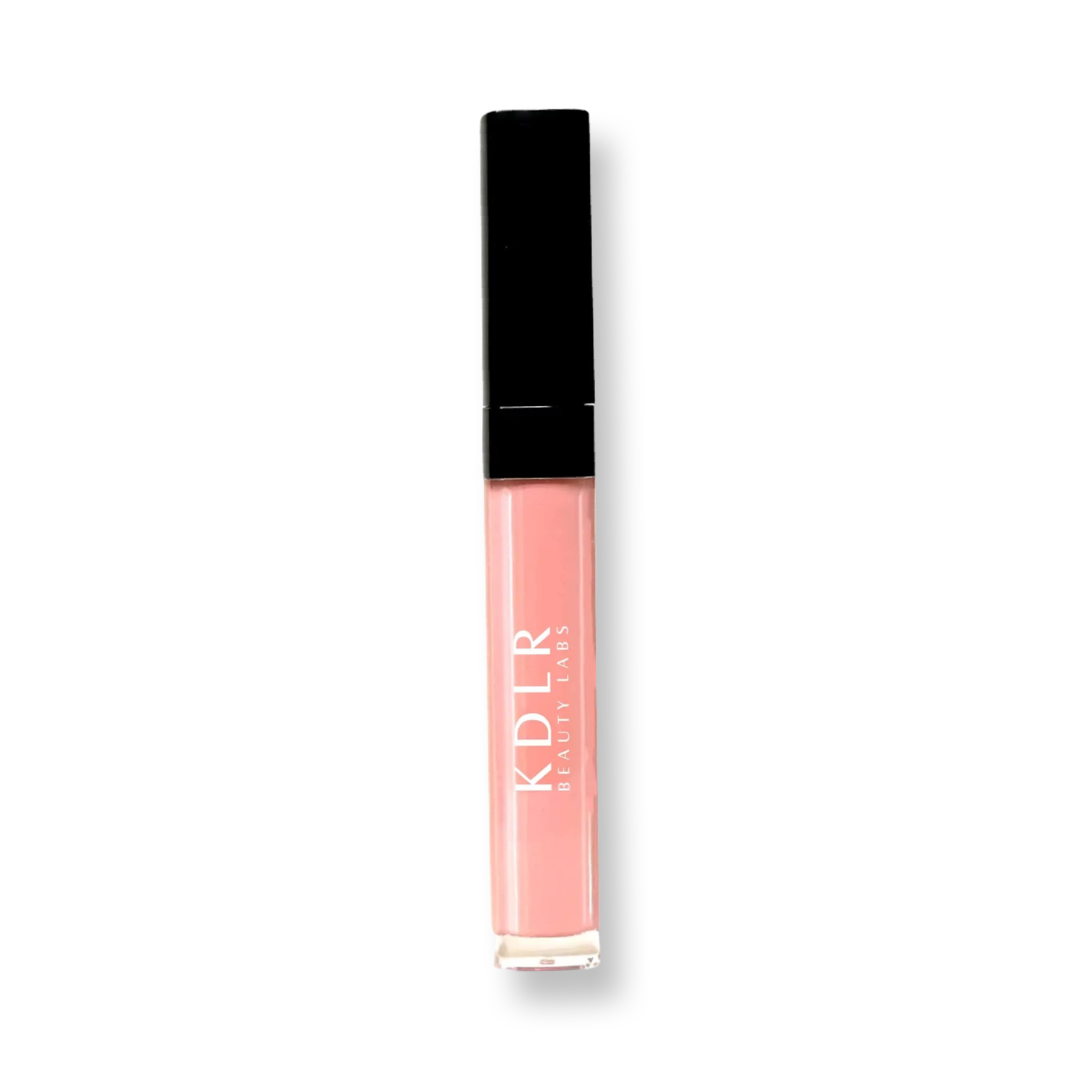 Close-up of Glow Infusion Lip Oil by KDLR Beauty Labs, showcasing its hydrating shimmer and elegant packaging. Variant: My Treat. A sheer flesh tone.