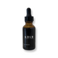 Bottle of KDLR Beauty Labs' Anti-Aging Rose Gold Oil amidst natural elements, showcasing the blend of rosehip oil and antioxidants for radiant skin.