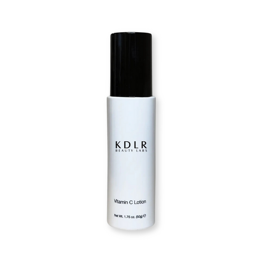 KDLR Beauty Labs Vitamin C Lotion bottle with a fresh tangerine and orange peel background, showcasing its hydrating and brightening benefits with ingredients like Vitamin C, aloe, glycerin, and rose hip extract.